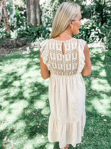 back view of cream embroidered midi dress